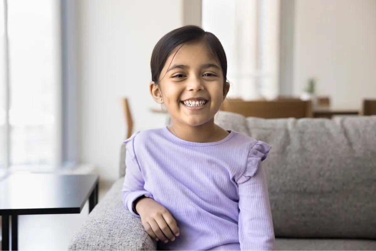Smiling girl relaxing comfortably at home