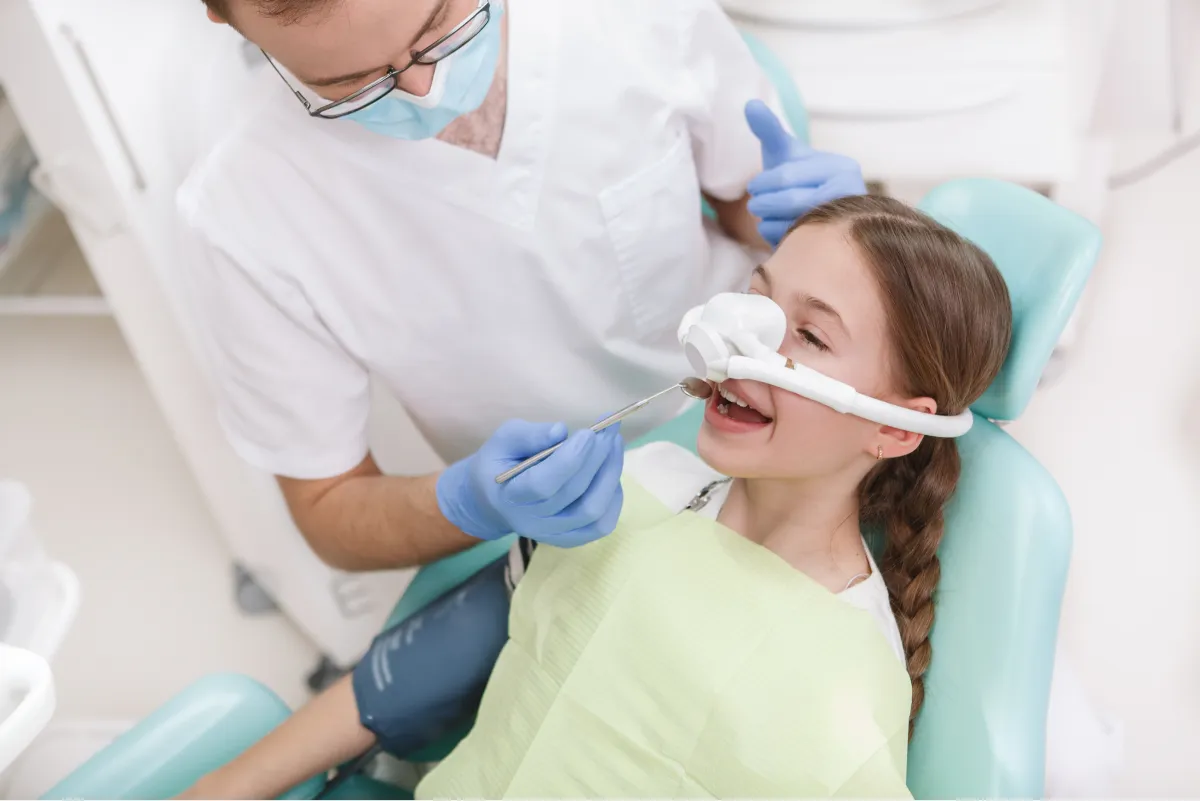 Child wearing nitrous oxide mask during gentle dental procedure